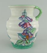 CROWN DUCAL CHARLOTTE RHEAD JUG of ribbed form with small upper section loop handle, in a floral