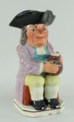 STAFFORDSHIRE PEARLWARE TOBY JUG of 'Wood' type circa 1790, seated with frothy jug of ale, clay pipe