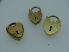 TWO NINE CARAT GOLD PADLOCKS, 5.4grms and a yellow metal (non-gold) padlock