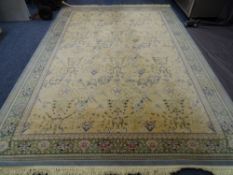 EASTERN STYLE TASSEL ENDED CARPET, traditional patters on a green and cream ground, 350 x 240cms