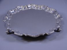 SILVER SALVER, plain form with stepped and wavy rim, on three scrolled feet, 25cms diameter, 17 ozs,