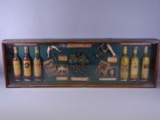 REPRODUCTION DISPLAY CASE OF WINE COLLECTABLES, 33cms high, 106cms long, 10cms deep