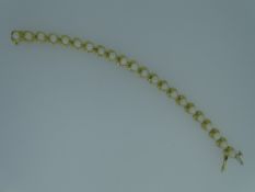FOURTEEN CARAT GOLD PEARL BRACELET, each pearl in a heart shaped set, 9.5grms