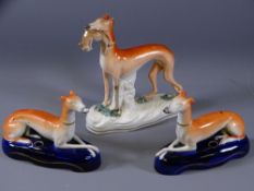 STAFFORDSHIRE GREYHOUND SPILLHOLDERS, a pair, on oval deep blue ground bases and a standing