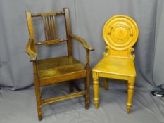 TWO ANTIQUE OAK CHAIRS including a farmhouse armchair and a circular back Victorian hall chair,