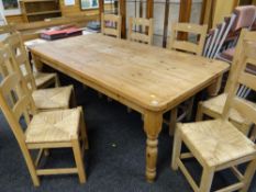 LARGE PITCH PINE DINING TABLE, 213 x 106cms and set of eight Arts & Crafts-style beech rush seated