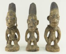 THREE YORUBA IBEJI FIGURES with beaded ornaments, 34cms high (3)