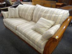 MODERN HARDWOOD & DOUBLE CANED SETTEE with over scrolled arms and loose regency stripe upholstery,