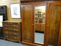VICTORIAN MAHOGANY TRIPLE WARDROBE, arched panel doors and replaced mirror centre, 178cms wide x