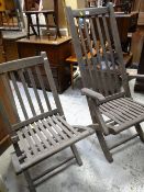 TWO H. CASTLE & SONS FOLDING TEAK GARDEN CHAIRS, made from reclaimed naval timber, one with