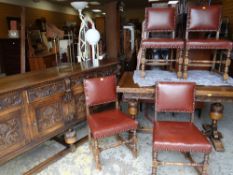 JACOBEAN-STYLE OAK DINING SUITE comprising carved draw leaf table, four red leather upholstered