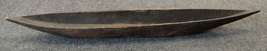 SMALL RIVER CANOE SHAPE FEAST BOWL, probably West African, 188cms