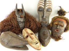 SIX VARIOUS AFRICAN MASKS including Songye Kifwebe mask, Guro antelope with raffin fringe, Lele mask