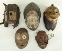 FIVE VARIOUS AFRICAN MASKS including ljo hippo mask, Lega mask, and Punu mask (5)