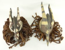 TWO MOSSI WAY-NYAKA ANIMAL DANCE CRESTS with plaited fibre fringes, 49cms (2)