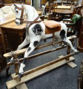 EARLY 20TH CENTURY DAPPLE ROCKING HORSE, leather mane, later saddle on trestle base, 143cms long
