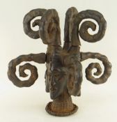 EKOI SKIN-COVERED HEADRESS with four faces and eight coiled and socketed braids, rattan base, 46cm