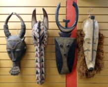 FOUR LARGE AFRICAN MASKS including crocodile mask, Fang ngil mask, Nafana bedu mask and another (4)