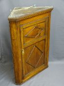 ANTIQUE OAK CORNER HANGING WALL CUPBOARD with single two panel door and applied beading, opening