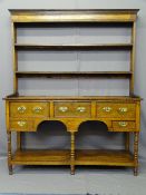 SHROPSHIRE OAK POTBOARD DRESSER, having two shelf open back rack with elongated shoes over a base