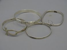 FOUR SILVER BANGLES to include square hinged example, total 1.6 troy ozs