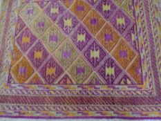 CAZAK RUG, muted pinks and greens with repeat pattern, central diamond block and multi-bordered