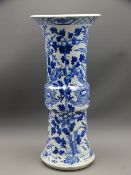 LARGE BLUE & WHITE ORIENTAL GU SHAPED VASE depicting two dragons on a floral background, 35cms H,
