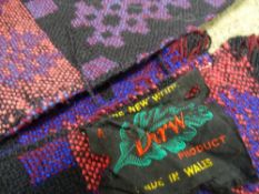 TWO TRADITIONAL WELSH WOOLLEN BLANKETS, matching purple tones in classical reversible patterns,
