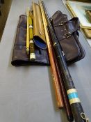 THREE SNOOKER CUES, a tin carry case and one other with a gent's brown leather effect suit