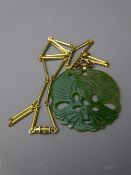 LARGE CARVED JADE PENDANT with 10k yellow gold scrolled hanger and yellow metal bar and rings