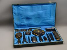 CHINESE TWELVE PIECE TORTOISESHELL DRESSING TABLE SET in original silk lined box, c1920, with carved