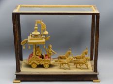 CARVED WOOD INDIAN DISPLAY depicting a horse drawn carriage, cased (glass missing)