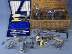 CASED CUTLERY and a collection of vintage and later corkscrews in a Moet & Chandon wicker basket