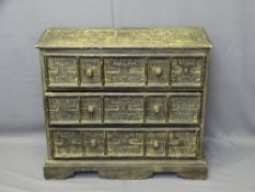 STAINED PINE CHEST of three drawers, having turned wooden knobs, carved Aztec type detail on
