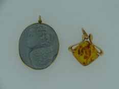 TWO NECKLACE PENDANTS, 14ct Russian gold and amber and a carved stone cameo type of a winged