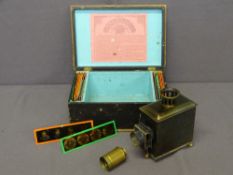 'LATERNA MAGICA' - a cased German tin plate slide lantern with a good quantity of coloured slides