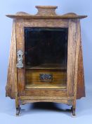 SMOKER'S CABINET - polished with outer end pipe racks and with a single bevelled glass door having