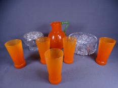 ORANGE GLASS SIX PIECE LEMONADE/WATER SET, the jug having a green handle, a cut glass fruit bowl and