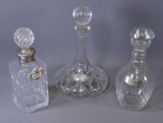 THREE GLASS DRINKS DECANTERS with stoppers and labels