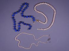 THREE CULTURED PEARLS & LAPIS LAZULI NECKLACES including a 47cms L near uniform strand of cultured