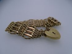SEVEN BAR 9CT GOLD GATE BRACELET with safety chain and bright cut padlock, 34.5grms
