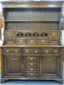 QUALITY REPRODUCTION OAK WELSH DRESSER having a canopy type two shelf rack with hanging hooks over a