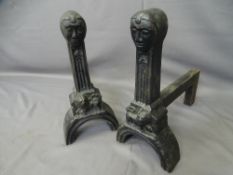 LARGE CAST IRON FIRE DOGS with standing lion and mask detail to the fronts, 48cms H, 48.5cms L, 16th