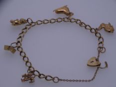 A 9CT GOLD FIVE CHARM BRACELET with padlock and chain, 13grms
