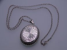AN OVAL BRIGHT CUT SILVER LOCKET & CHAIN, 19grms