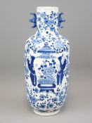 BLUE & WHITE ORIENTAL FIGURAL VASE with floral background, 31cms H, Kangxi marks to the base, 19th