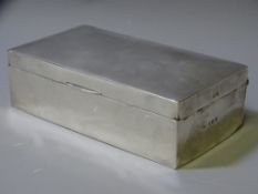 AN OBLONG WOODEN CIGARETTE BOX, silver mounted throughout, Birmingham 1911 by H W Williamson