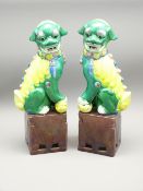 PAIR OF FAMILLE VERTE TEMPLE DOGS, LATE CHINESE of typical form seated on square aubergine bases