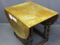 ANTIQUE STYLE OAK GATELEG DINING TABLE on turned supports and block stretchers, 77.5cms H, 90cms
