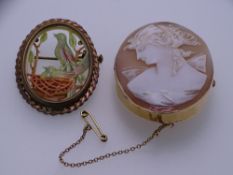 A 9CT GOLD OVAL CAMEO BROOCH, 4.7 x 3.7cms and a yellow metal oval Jadeite style brooch featuring